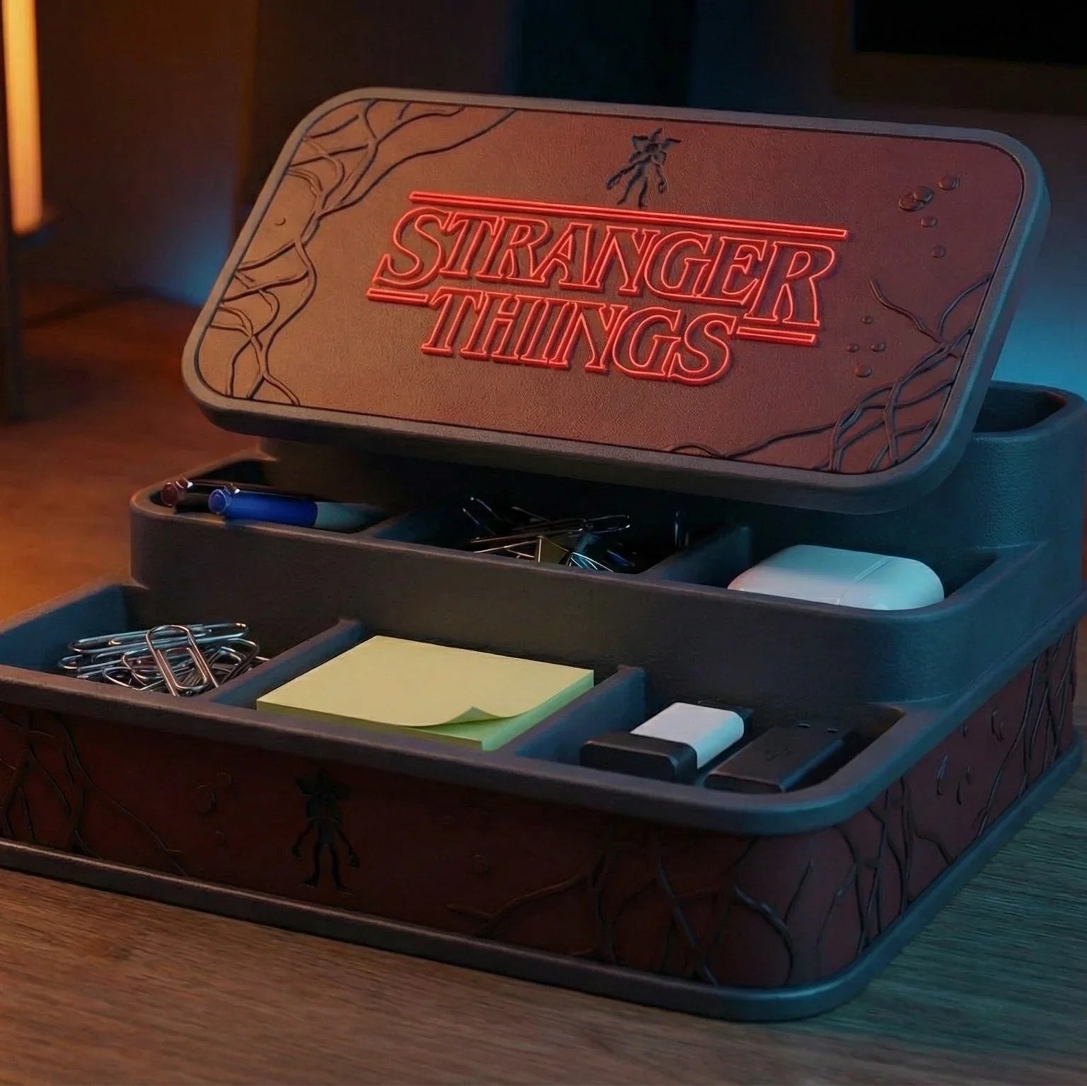 Stranger Things themed desk organizer with compartments for office supplies on wooden workspace.