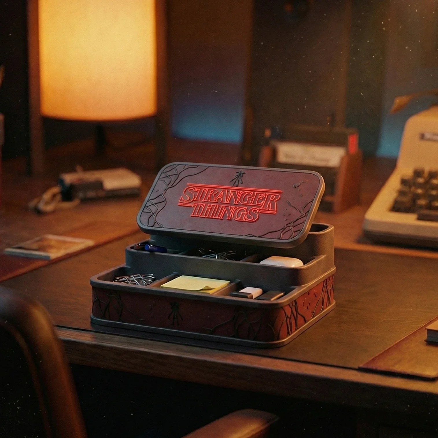 Stranger Things themed desktop organizer box holding office supplies on a workspace desk