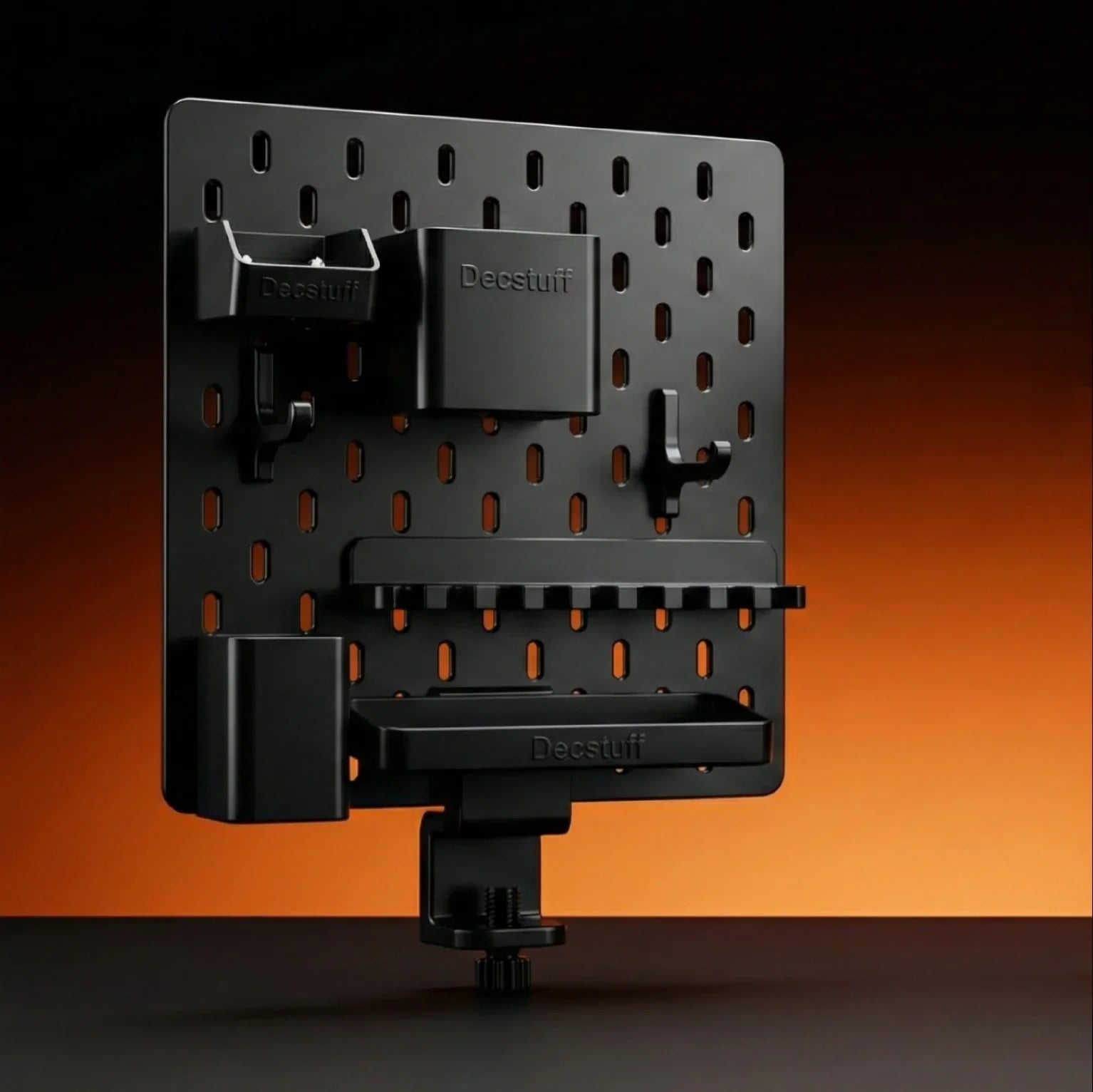 Decstuff modular pegboard organizer in black with multiple hooks and containers on a desk