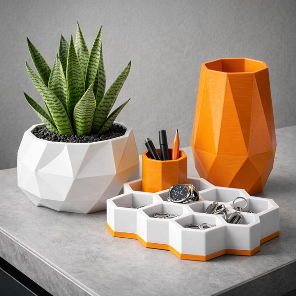 Geometric desk organizer with geometric plant pot and orange vase on a gray surface.