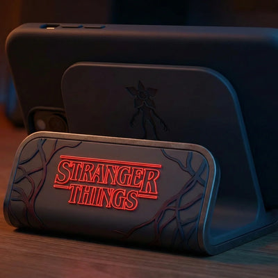 Desk organizer with Stranger Things logo, dark design, on wooden surface for workspace storage