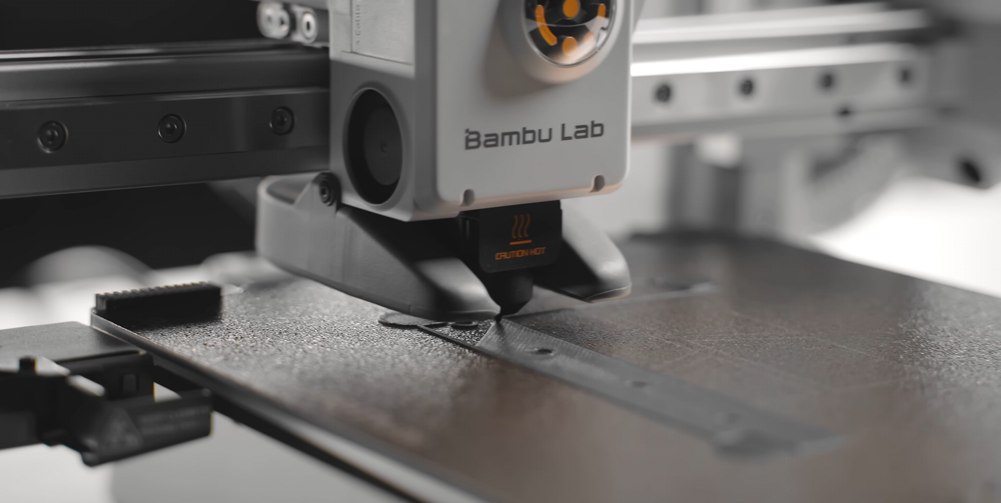 Bambo Lab machine on a workbench with metal cutting in progress